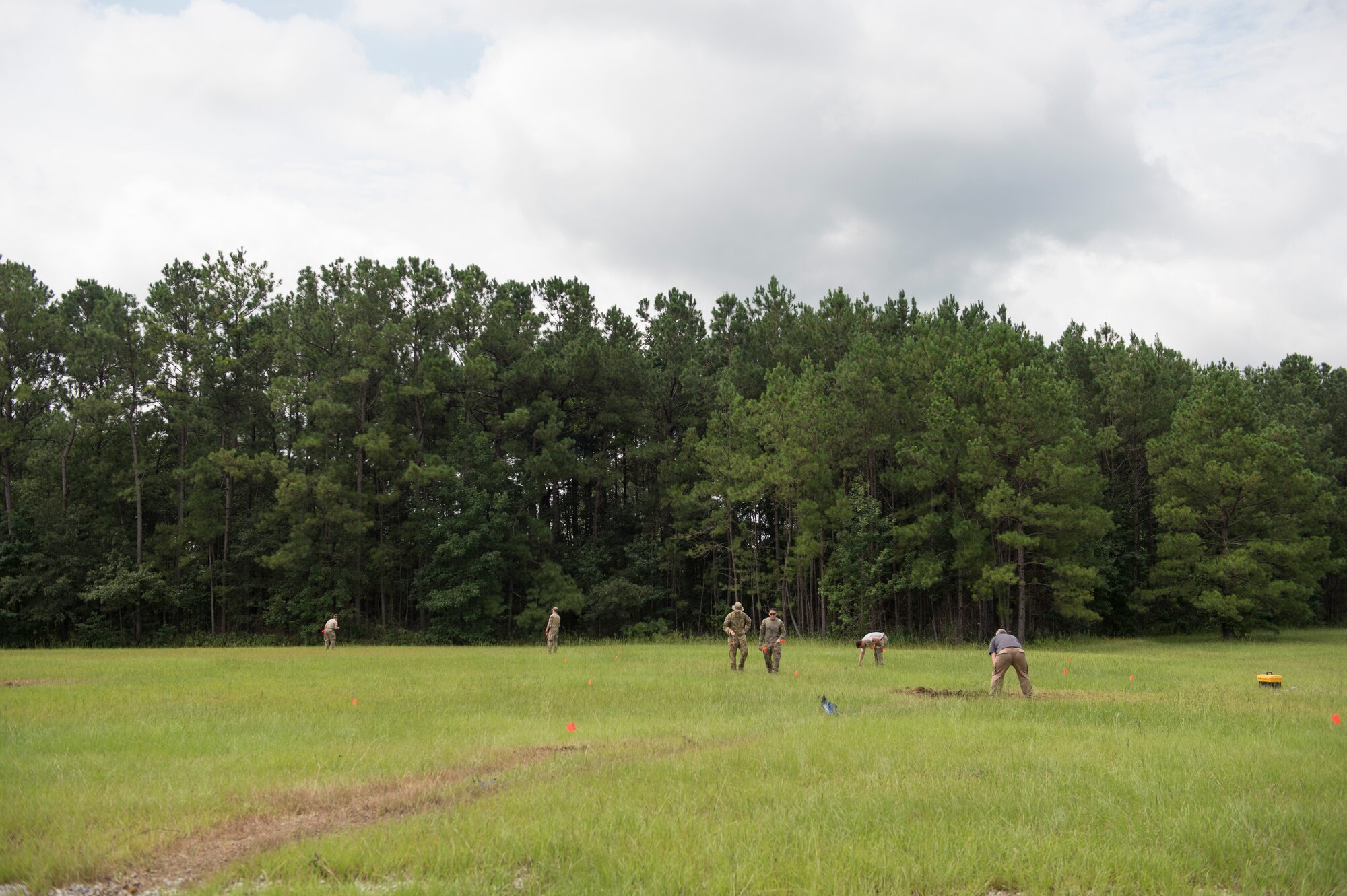 Airmen and a Soldier set a cordon around a controlled explosion site, Aug. 3, 2016 at Joint Base Charleston – Weapons Station, S.C. The joint post-blast analysis training exercise included 22 participants from the Kentucky Air National Guard, South Carolina Air National Guard, Army South Carolina Guard, MacDill Air Force Base, Fla. Seymour Johnson Air Force Base, N.C., 628th Civil Engineering Squadron and 315th CEF. The trainees honed their skills of collecting evidence after an IED attack. (U.S. Air Force photo/Staff Sgt. Jared Trimarchi)