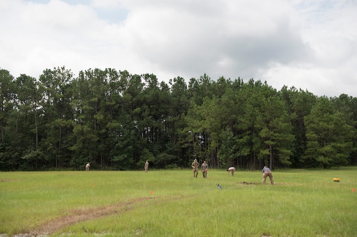 Airmen and a Soldier set a cordon around a controlled explosion site, Aug. 3, 2016 at Joint Base Charleston – Weapons Station, S.C. The joint post-blast analysis training exercise included 22 participants from the Kentucky Air National Guard, South Carolina Air National Guard, Army South Carolina Guard, MacDill Air Force Base, Fla. Seymour Johnson Air Force Base, N.C., 628th Civil Engineering Squadron and 315th CEF. The trainees honed their skills of collecting evidence after an IED attack. (U.S. Air Force photo/Staff Sgt. Jared Trimarchi)