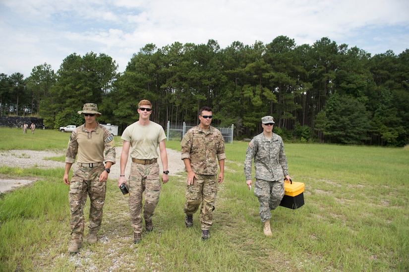 Airmen and a Soldier walk toward a controlled explosion site, Aug. 3, 2016 at Joint Base Charleston – Weapons Station, S.C. The joint post-blast analysis training exercise included 22 participants from the Kentucky Air National Guard, South Carolina Air National Guard, Army South Carolina Guard, MacDill Air Force Base, Fla. Seymour Johnson Air Force Base, N.C., 628th Civil Engineering Squadron and 315th CEF. The trainees honed their skills of collecting evidence after an IED attack. (U.S. Air Force photo/Staff Sgt. Jared Trimarchi)