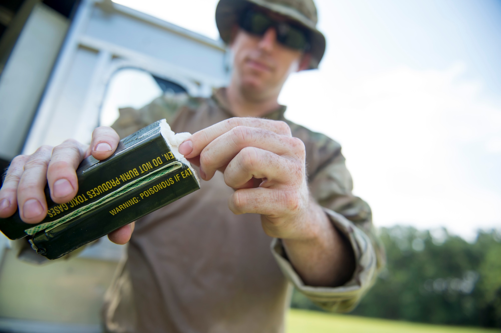 Tech. Sgt. Brenden MCavey, 315th Civil Engineering flight Explosive Ordnance Disposal technician, shows the inside of a stick of C-4 explosive, Aug. 3, 2016 at Joint Base Charleston – Weapons Station, S.C. The joint post-blast analysis training exercise included 22 participants from the Kentucky Air National Guard, South Carolina Air National Guard, Army South Carolina Guard, Mac Dill Air Force Base, Fla. Seymour Johnson Air Force Base, N.C., 628th Civil Engineering Squadron and 315th CEF. The trainees honed their skills of collecting evidence after an IED attack. (U.S. Air Force photo/Staff Sgt. Jared Trimarchi)