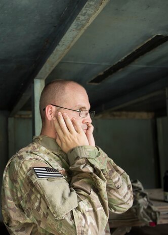 Tech. Sgt. Dwayne Ferguson, 628th Civil Engineering Squadron Explosive Ordnance Disposal team lead, covers his ears during a controlled explosion, Aug. 3, 2016 at Joint Base Charleston – Weapons Station, S.C. The joint post-blast analysis training exercise included 22 participants from the Kentucky Air National Guard, South Carolina Air National Guard, Army South Carolina Guard, MacDill Air Force Base, Fla. Seymour Johnson Air Force Base, N.C., 628th Civil Engineering Squadron and 315th Civil Engineering Flight. The trainees honed their skills of collecting evidence after an IED attack. (U.S. Air Force photo/Staff Sgt. Jared Trimarchi) 