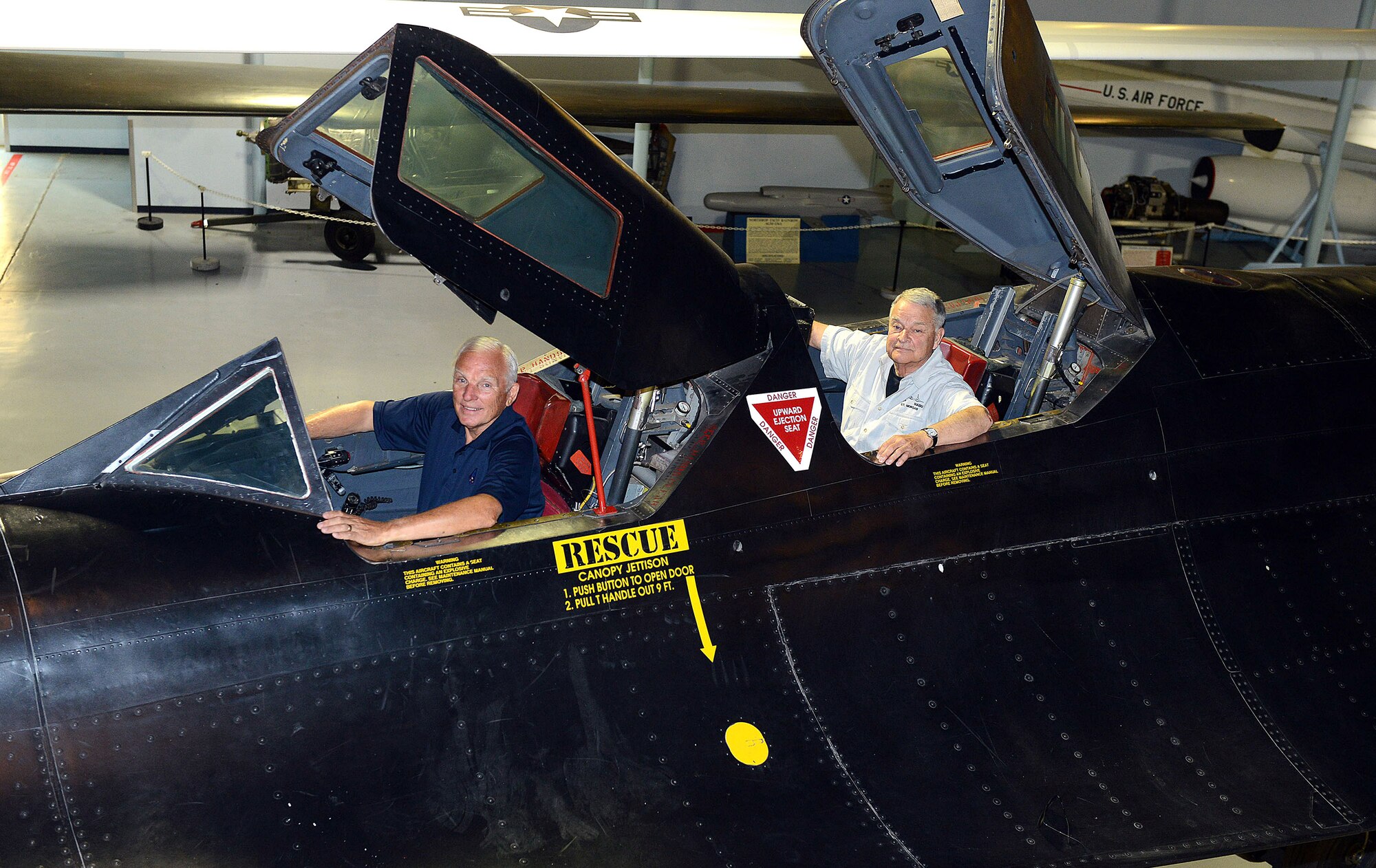 Retired Maj. Gen. Eldon Joersz, a former pilot, and retired Lt. Col. George Morgan, a former reconnaissance systems officer, sit inside the cockpit of the SR-71 Blackbird they flew when setting the world absolute speed record for jet-powered aircraft July 28, 1976. The two were at the Museum of Aviation in Warner Robins, Georgia, for the 40th anniversary of the historic flight. (U.S. Air Force photo/Tommie Horton)