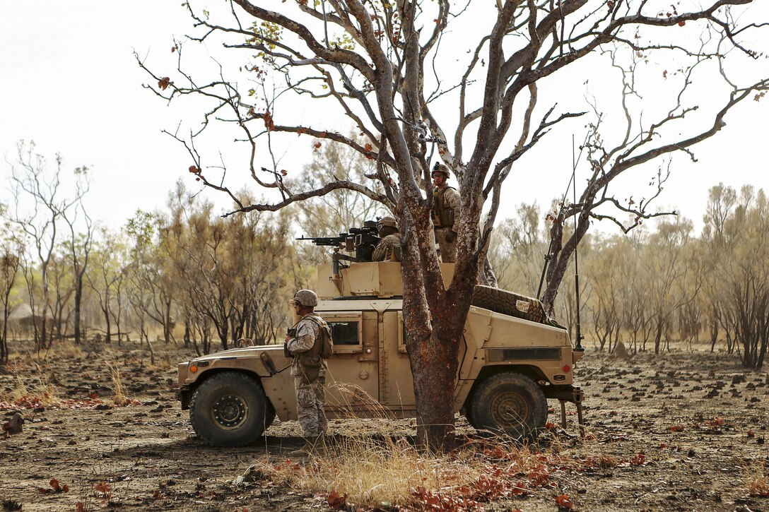Marines scan for targets while training in maneuvering through a wooded area in a convoy operation during Exercise Koolendong 16 at Bradshaw Field Training Area, Northern Territory, Australia, Aug. 8, 2016. The Marines are assigned to Combined Anti-Armored Team, 1st Battalion, 1st Marine Regiment. Marine Corps photo by Sgt. Sarah Anderson