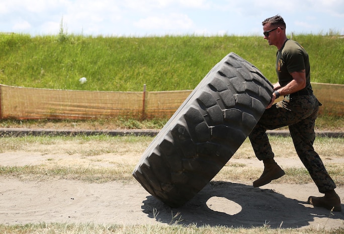 U.S. Marine Corps Sgt. Michael Eckert, quality control chief of motor transport company, Marine Wing Support Squadron 171, flips a tire during physical training at Marine Corps Air Station Iwakuni, Japan, Aug. 8, 2016. Eckert is the top male contender from the air station to attend the Second Annual High Intensity Tactical Training Ultimate Athlete Championship from Aug. 15-18, 2016, at MCAS Miramar, California. Among him, nearly three dozen U.S. Marines from across the globe will square off in this grueling three day competition that will test their mental and physical strengths to the maximum. (U.S. Marine Corps photo by Sgt. Jessica Quezada)