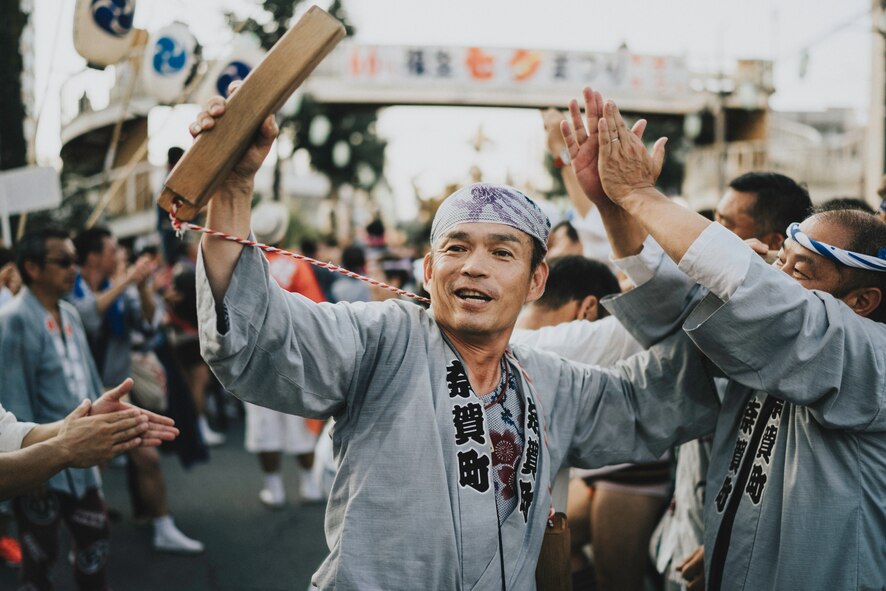 A man helps direct people carrying a mikoshi, or portable shrine, in the 66th Annual Fussa Tanabata Festival at Fussa City, Japan, Aug. 5, 2016. Fussa, a city neighboring Yokota Air Base, hosts the festival every year, offering a local and convenient option for Yokota members to experience Japanese culture. (U.S. Air Force photo by Senior Airman Delano Scott/Released)