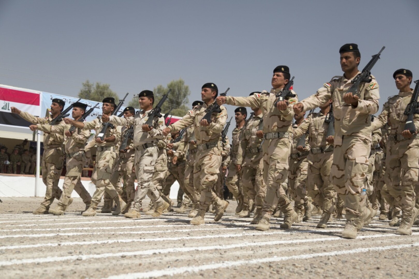 Iraqi soldiers assigned to the Iraqi army’s 76th Brigade, 16th Division, march past the reviewing stand during the brigade’s graduation at Camp Taji, Iraq, June 28, 2015. Through advise, assist and build partner-capacity missions, the Combined Joint Task Force – Operation Inherent Resolve’s multinational coalition has trained more than 10,000 Iraqi security force personnel to defeat the Islamic State of Iraq and the Levant. Army photo by Sgt. Charles M. Bailey 