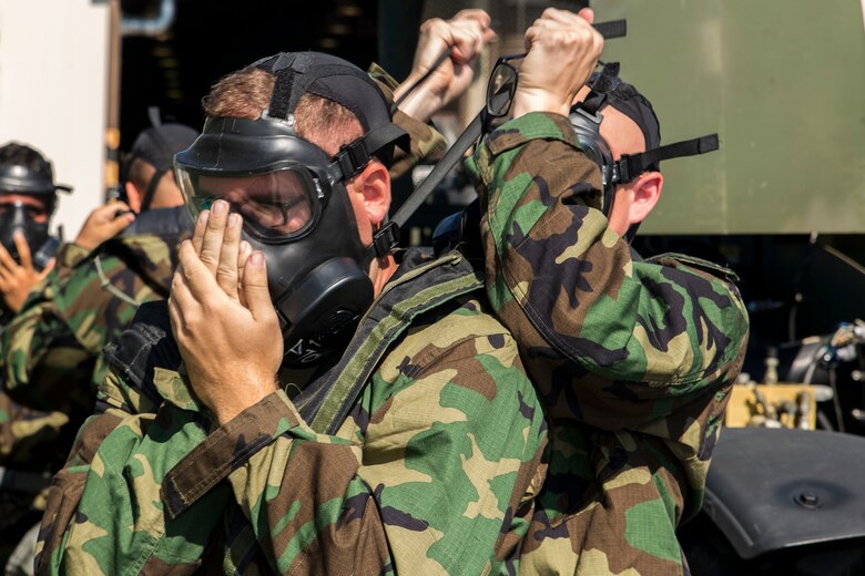 U.S. Marines with Combat Logistics Company 36 don their M50 Joint Service General Purpose Masks during chemical, biological, radiological and nuclear defense training at Marine Corps Air Station Iwakuni, Japan, Aug. 10, 2016. Marines, already in mission oriented protective posture gear, were evaluated on their ability to effectively detect, report, respond and operate in a simulated CBRN environment. When given the signal “gas, gas, gas,” Marines scrambled to don their M50 Joint Service General Purpose Masks before returning to work as if everything was normal. Conducting this training helps Marines refresh their tactical skill sets specific to CBRN response, maintain situational readiness and ensures the safety of personnel. (U.S. Marine Corps photo by Lance Cpl. Aaron Henson)