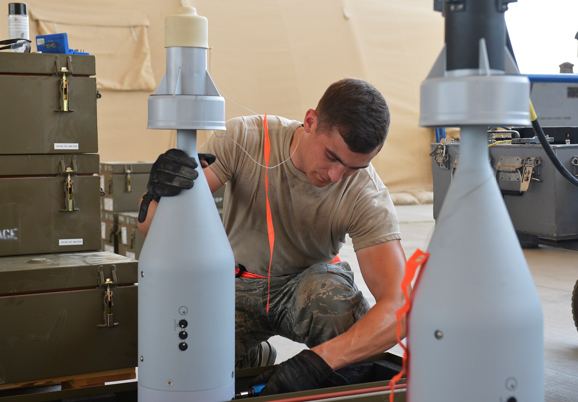 An Airman assigned to the 380th Expeditionary Maintenance Squadron secures a precision guided munition at an undisclosed location. A flight of approximately 100 munitions experts ensure the appropriate weapons are built, maintained and delivered to the strike aircraft supporting Operation Inherent Resolve. (U.S. Air Force photo by Capt Sybil Taunton)