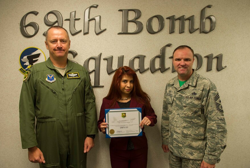 Ermelinda Torres, 69th Bomb Squadron command support staff, receives the 5th Bomb Wing "Own It" Award at Minot Air Force Base, N.D., Aug. 5, 2016. Torres overhauled squadron in-processing procedures, allowing new members to expeditiously start Mission Qualification Training.  She processed more than 70 performance reports, awards, decorations, and promotion recommendation forms and streamlined OPR and EPR processes, personally ensuring that squadron records are current and that members are promotion board-ready, while decreasing the submission timeline by over 50 percent. Finally, Mrs. Torres selflessly donated her time to support the Airman's Attic, enhancing
quality of life for Minot AFB Airmen and exemplifying the definition of "Own It" both on- and off-duty.
