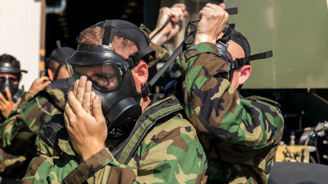 U.S. Marines with Combat Logistics Company 36 don their M50 Joint Service General Purpose Masks during chemical, biological, radiological and nuclear defense training at Marine Corps Air Station Iwakuni, Japan, August 10, 2016. Marines, already in mission oriented protective posture gear, were evaluated on their ability to effectively detect, report, respond and operate in a simulated CBRN environment. When given the signal “gas, gas, gas,” Marines scrambled to don their M50 Joint Service General Purpose Masks before returning to work as if everything was normal. Conducting this training helps Marines refresh their tactical skill sets specific to CBRN response, maintain situational readiness and ensures the safety of personnel. 