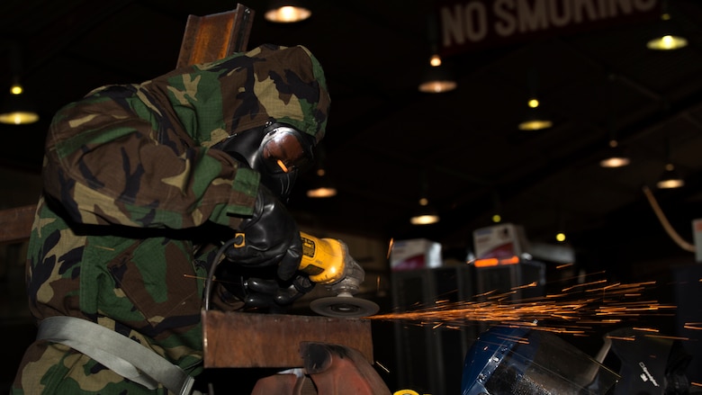 U.S. Marine Corps Lance Cpl. Trevon Bruce, a metal worker with Combat Logistics Company 36, grinds steel during chemical, biological, radiological and nuclear defense training at Marine Corps Air Station Iwakuni, Japan, August 10, 2016. Marines, already in mission oriented protective posture gear, were evaluated on their ability to effectively detect, report, respond and operate in a simulated CBRN environment. When given the signal “gas, gas, gas,” Marines scrambled to don their M50 Joint Service General Purpose Masks before returning to work as if everything was normal.