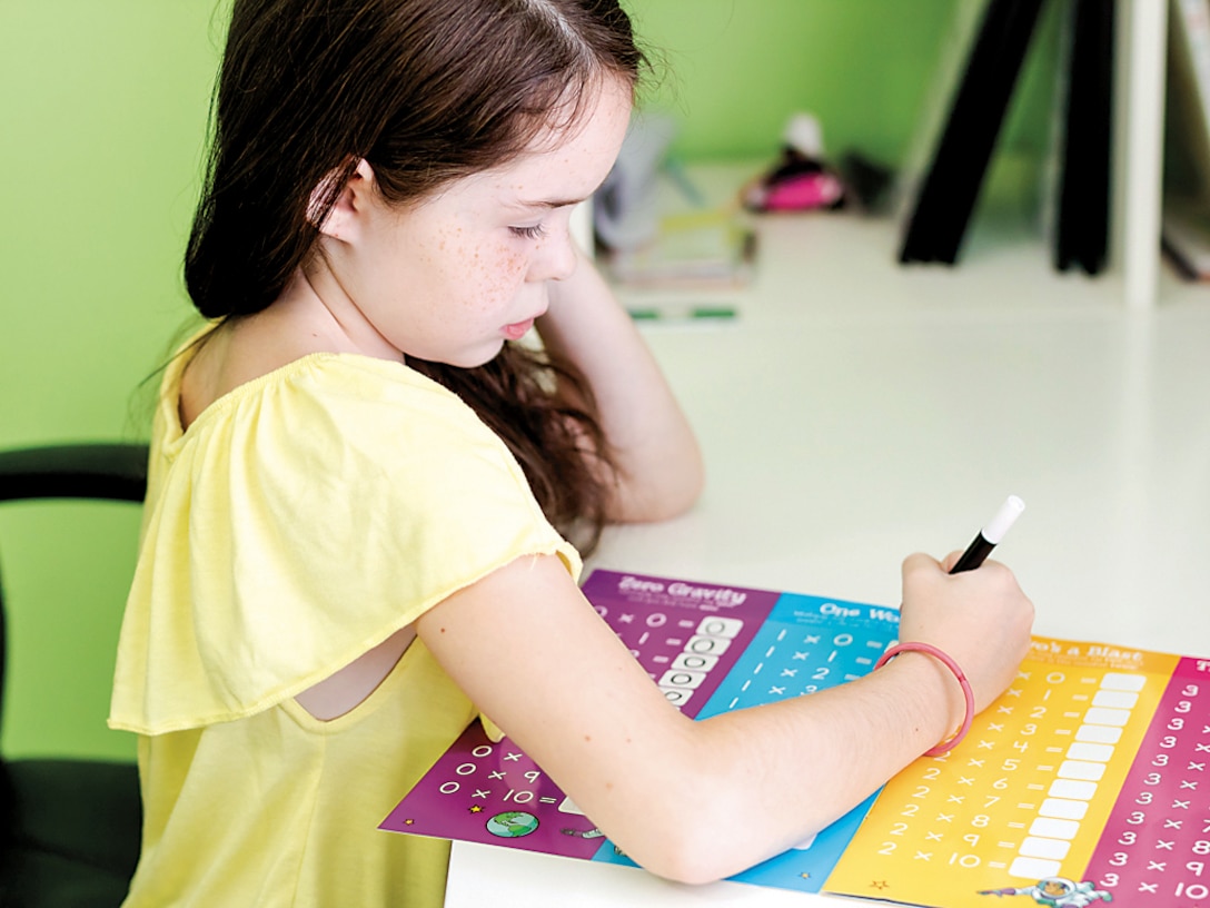 Angela Powell Woulfe’s 8-year-old daughter works on her multiplication tables in her home schoolroom Aug. 8. Woulfe will home-school her daughter this year.