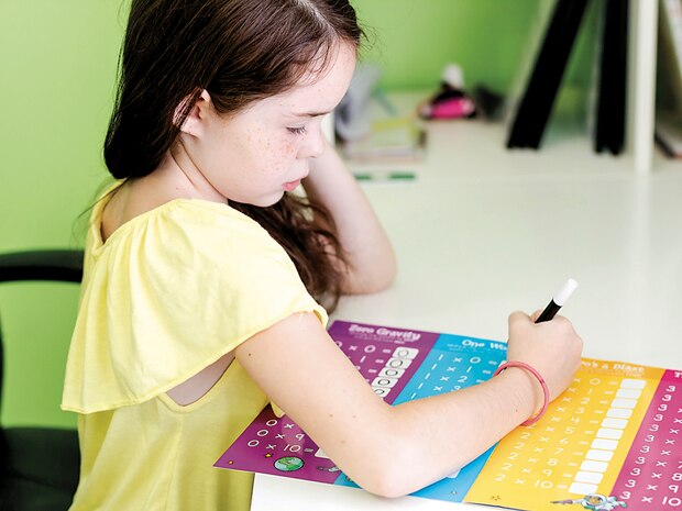 Angela Powell Woulfe’s 8-year-old daughter works on her multiplication tables in her home schoolroom Aug. 8. Woulfe will home-school her daughter this year.