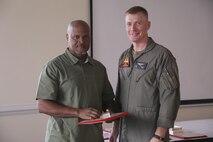 Col. Russell Burton, Marine Corps Air Station New River commanding officer, presents Eric Clark, New River Safety Department safety specialist, with a 30 year service award during the Quarterly Civilian Breakfast at the officer’s club on the air station Aug. 3. The event brought together civilians from around New River to recognize civilian award winners and conduct annual training. (U.S. Marine Corps photo by Cpl. Mark Watola /Released)