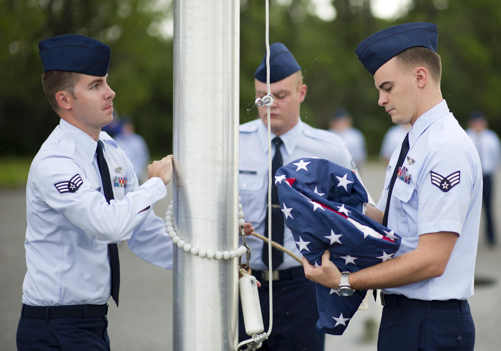 The Tyndall Airman Leadership School flag detail team prepares to hoist the U.S. flag during Reveille at Tyndall Air Force Base, Fla., Aug. 8, 2016. Students in ALS are taught lessons in leadership theory, effective communication, resource stewardship, military customs and courtesies and physical fitness. (U.S. Air Force photo by Staff Sgt. Alex Fox Echols III/Released)
