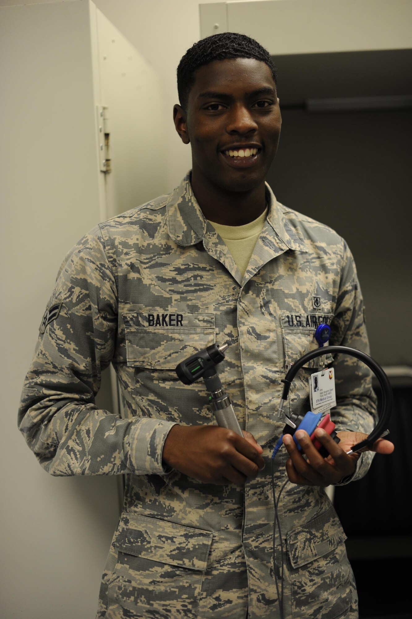 Airman 1st Class Kevin B. Baker, 87th Aerospace Medicine Squadron public health technician, poses for a photo with audiogram (hearing test) equipment at the 87th Medical Group on Joint Base McGuire-Dix-Lakehurst, N.J., Aug. 10, 2016. Baker and the Public Health team worked extra hours to assist night shift aircraft maintainers from the 305th Aircraft Maintenance Squadron.
