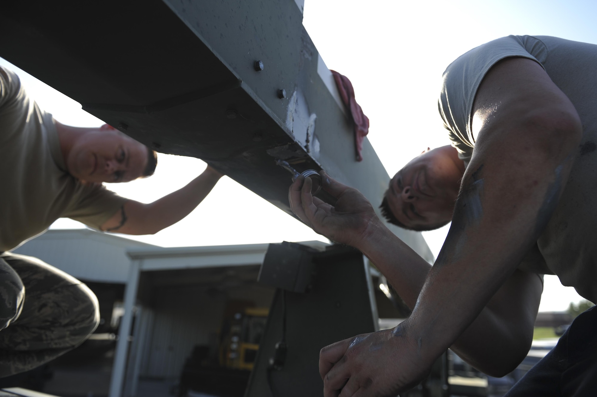(From left) U.S. Air Force Staff Sgt. Ryan Ayres and U.S. Air Force Staff Sgt. Christopher Dietz, 19th Logistics Readiness Squadron Mission Generation Vehicular Equipment Maintenance craftsmen, apply lubricant to the boom wear pads of a deicer Aug. 3, 2016, at the 19th LRS Vehicle Maintenance shop, on Little Rock Air Force Base, Ark. The application of lubricant eliminates excess motion when the boom is extended and retracted, thus ensuring more reliability. (U.S. Air Force photo by Airman Grace Nichols)