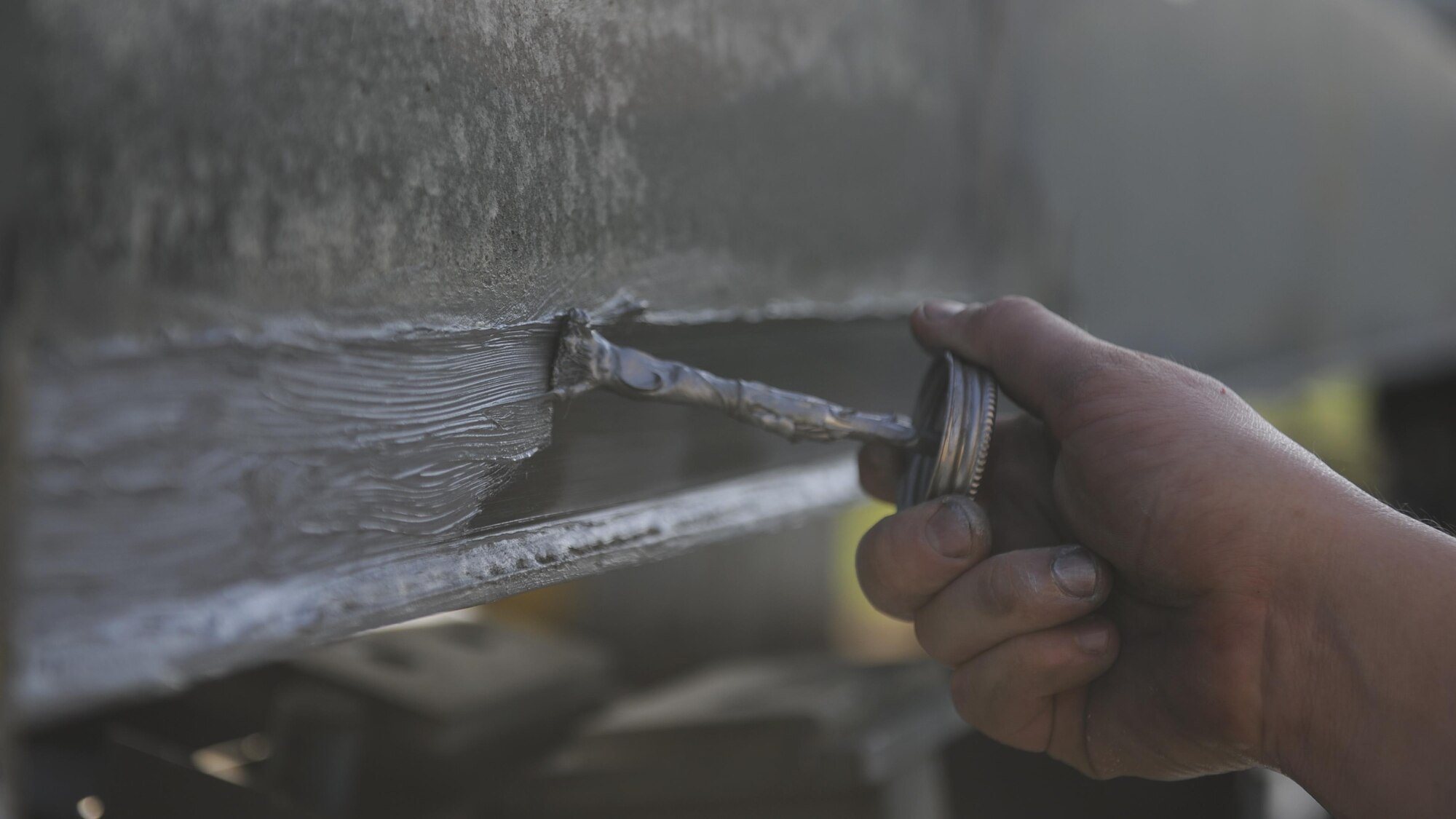 A Mission Generation Vehicular Equipment Maintenance craftsman from the 19th Logistics readiness Squadron maintenance shop applies lubricant to the boom wear pads of a deicer Aug. 3, 2016, on Little Rock Air Force Base, Ark. The purpose of the boom wear pads is to prevent metal on metal contact between the inner and outer boom in order for the device function properly. (U.S. Air Force photo by Airman Grace Nichols)