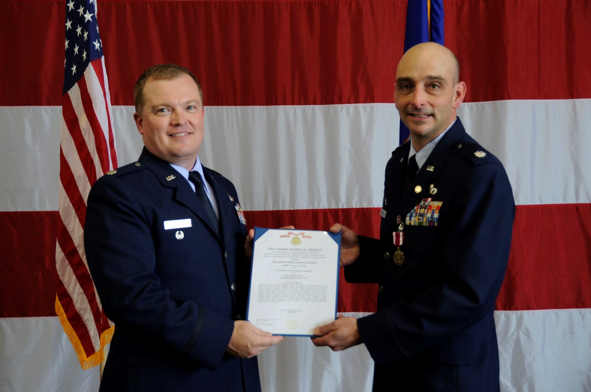 PETERSON AIR FORCE BASE, Colo. - Lt. Col. John Anderson, 302nd Civil Engineer Squadron commander (right), was awarded the Meritorious Service Medal during his retirement ceremony July 17, 2016 here. Anderson retired
after 22 years of service, 13 of which were spent as part of the 302nd CES. Under his command, the 302nd CES participated in five deployed-for-training operations, and set the Air Force benchmark for Total Force Integration combining the Air Reserve Component with the 21st CE Explosive Ordnance Disposal Flight. Lt. Col. Samuel Brown (left), 302nd Mission Support Group deputy commander, presided over the ceremony and said, "Lt. Col. John
Anderson embodies the purpose of leadership. That purpose is to care and to serve." Anderson offered his thanks to the squadron, "It was an honor and a privilege to serve with each and every one of you. To your families, pass on
my gratitude." (U.S. Air Force photo/ Capt. Cait Suttie)