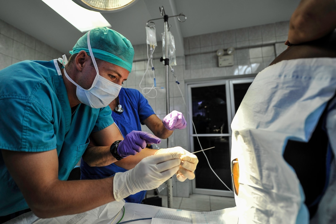 U.S. Navy Lt. Pierre Cagniart, Special Purpose Marine Air-Ground Task Force flight surgeon, prepares to perform a spinal on a patient during a Joint Task Force-Bravo Medical Element Mobile Surgical Team operation at the Dr. Salvador Paredes Hospital in Trujillo, Honduras, July 28, 2016. The MST performed 11 surgeries during the team’s three-day operation in Trujillo.