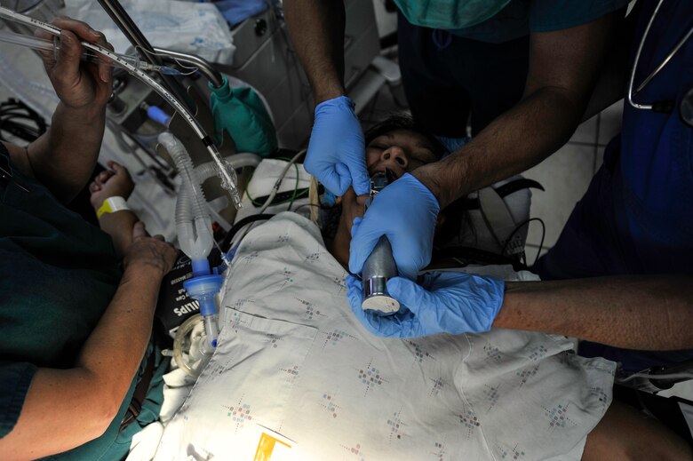 Members of the Joint Task Force-Bravo Medical Element Mobile Surgical Team intubate a patient during a MEDEL MST operation at the Dr. Salvador Paredes Hospital in Trujillo, Honduras, July 28, 2016. The patients treated by the MST during this operation in Trujillo were first screened by the doctors of the Dr. Salvador Paredes Hospital and recommended for the surgeries based on the severity of their injuries, how long they've had the problem, and lack of means to pay for the surgeries.