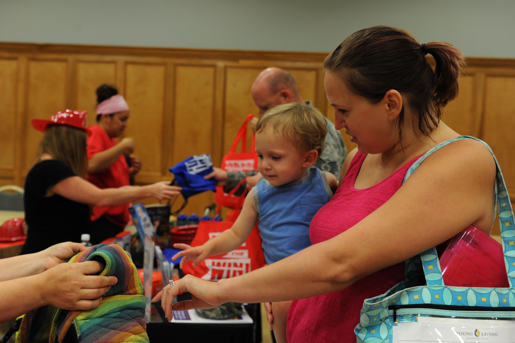 Amy Tatangelo and her son, Rocco Tatangelo, visit the vendors at the Back-to-School Brigade event Aug. 5, 2016, at the Walters Community Support Center on Little Rock Air Force Base, Ark. The event was part of Operation Homefront’s efforts to distribute backpacks and school supplies throughout the country. (U.S. Air Force photo by Airman Grace Nichols)