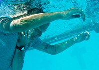 Senior Airman Ryan Praleikas, 5th Medical Operations Squadron emergency medical technician, plays the role of a drowning victim during training at Minot Air Force Base, N.D., Aug. 10, 2016. The water extraction training involved performing emergency medicine on a simulated patient in a water environment. (U.S. Air Force photo/Airman 1st Class J.T. Armstrong)