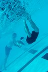 An Airman from the 5th Medical Operations Squadron swims to a simulated victim during training at the base pool at Minot Air Force Base, N.D., Aug. 10, 2016. The training was to help prepare the team for the EMT Rodeo, an Air Force-level competition held at Cannon AFB, N.M. (U.S. Air Force photo/Airman 1st Class J.T. Armstrong)