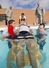 Airmen from the 5th Medical Operations Squadron extract a simulated patient during training at the base pool at Minot Air Force Base, N.D., Aug. 10, 2016. The purpose of the training was to practice for the EMT Rodeo, an Air Force-level competition held at Cannon AFB, N.M. The 5th MDOS Airmen were hand-selected to represent Air Force Global Strike Command in the competition. (U.S. Air Force photo/Airman 1st Class J.T. Armstrong)