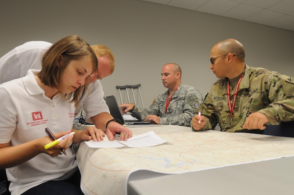 Members of the Savannah District's Temporary Emergency Power Team and 249th Engineer Battalion chart locations of life-saving facilities during a regional power mission exercise conducted July 20 at the Federal Emergency Management Agency Distribution Center in Atlanta, Georgia.