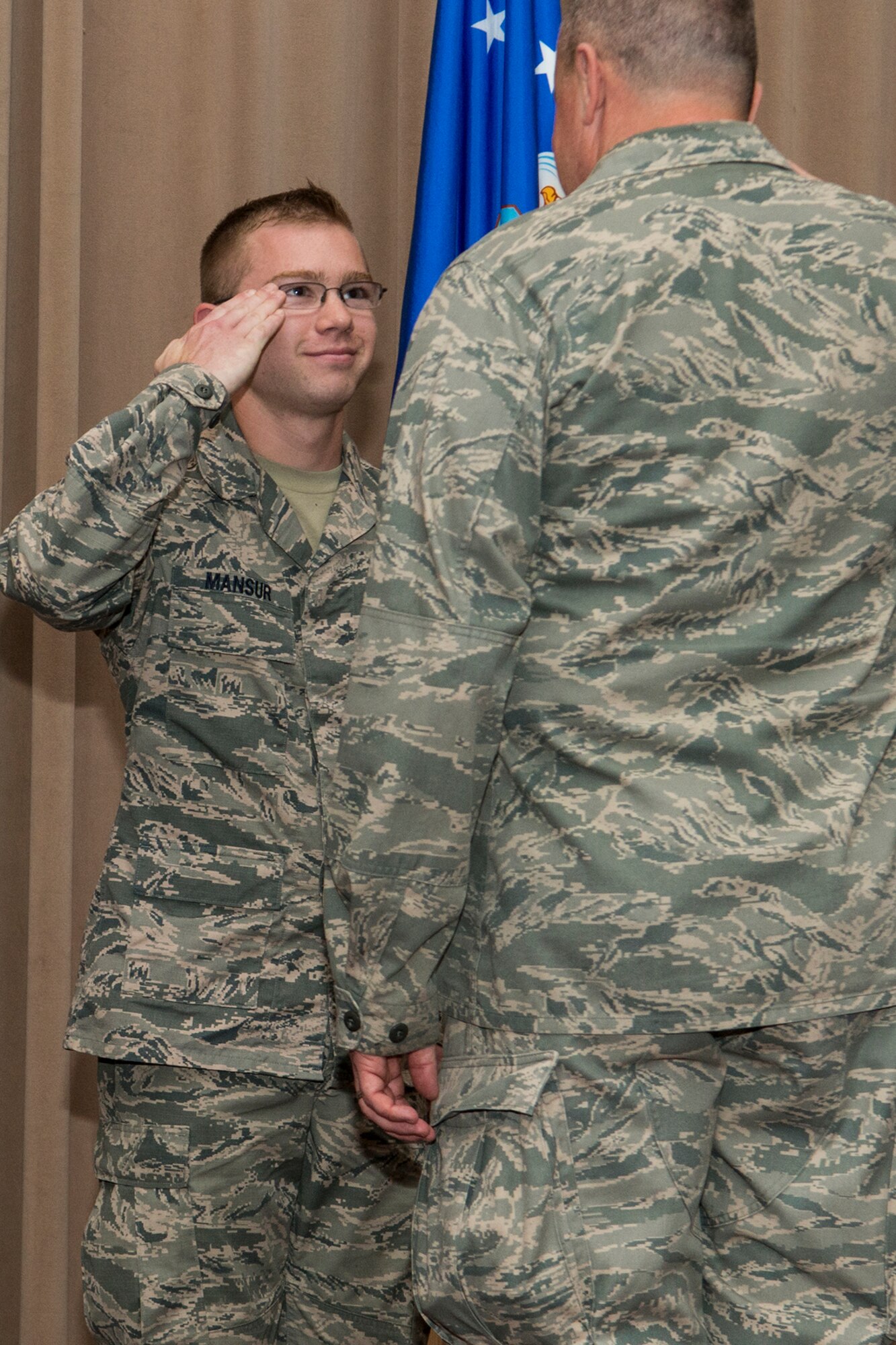 U.S. Air Force Col. Bruce Cox, 307th Bomb Wing commander, congratulates Senior Airman Brian Mansur during a commander’s call on Aug. 7, 2016, Barksdale Air Force Base, La. Mansur was cited by the Air Force Reserve Command’s Inspector General team as the “best personnel evaluation seen to date” during a Unit Effectiveness Inspection Capstone. (U.S. Air Force photo by Master Sgt. Greg Steele/Released)