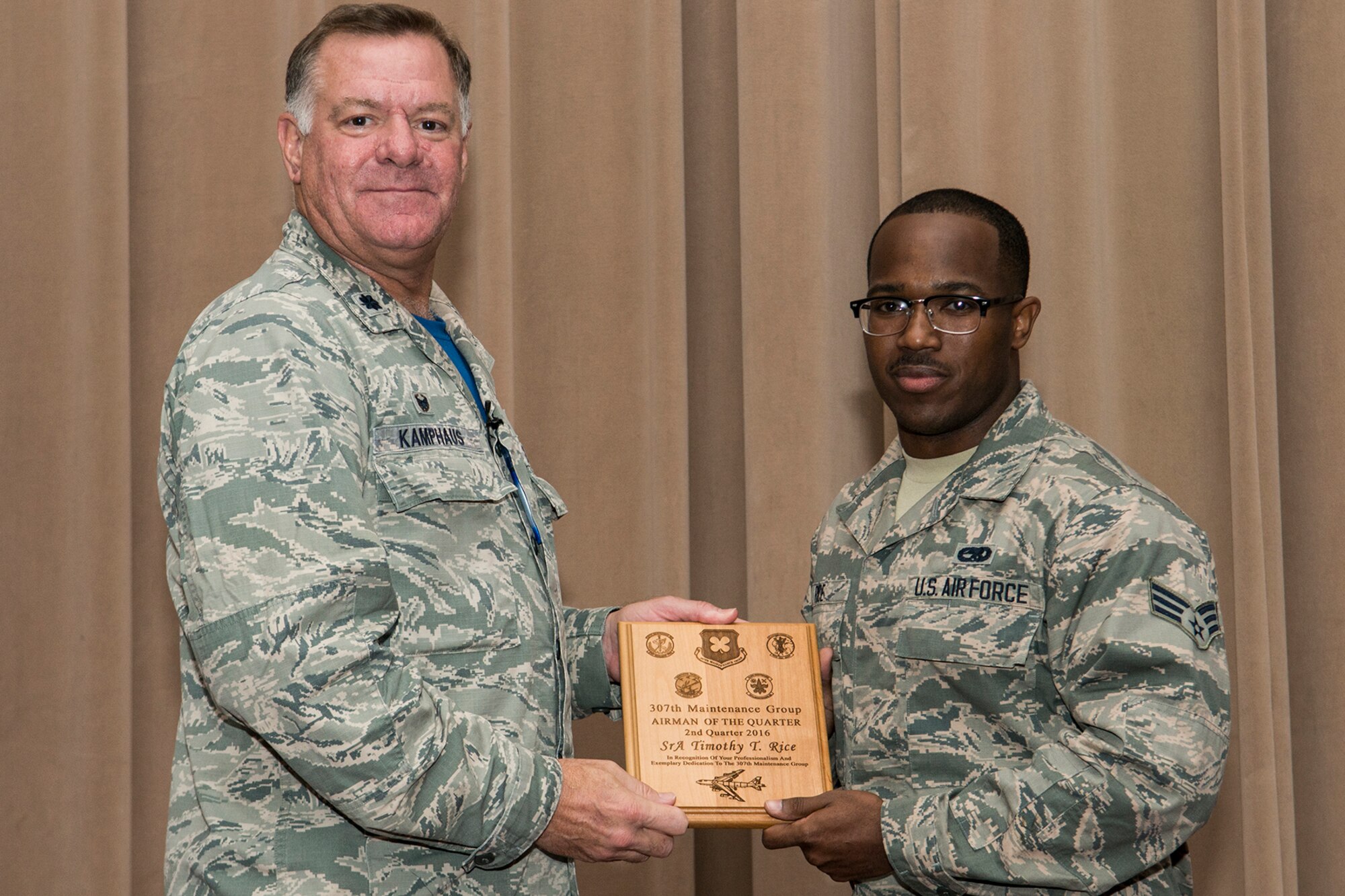 U.S. Air Force Lt. Col. Leo Kamphaus, 307th Maintenance Group (MXG) commander, presents an award to Senior Airman Timothy Rice during a commander’s call on Aug. 7, 2016, Barksdale Air Force Base, La. Rice was selected as the 307th MXG Airman of the Quarter for the period covering April to June 2016. (U.S. Air Force photo by Master Sgt. Greg Steele/Released)