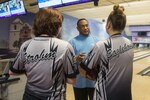 Steve Barinque (center), Joint Base San Antonio-Randolph Bowling Center manager, instructs Sydney Strohm (left) and Megan Eaglehouse (right), Steele High School bowling team members, during a practice Aug. 3 at JBSA-Randolph’s Bowling Center. 