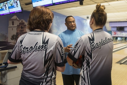 Steve Barinque (center), Joint Base San Antonio-Randolph Bowling Center manager, instructs Sydney Strohm (left) and Megan Eaglehouse (right), Steele High School bowling team members, during a practice Aug. 3 at JBSA-Randolph’s Bowling Center. 