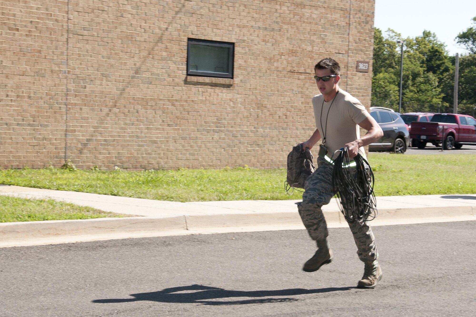 A member of the 459th Aircraft Maintenance Squadron runs toward the flight line after being alerted to a mission during a readiness exercise on Joint Base Andrews, Md., Sunday, Aug. 7, 2016. The exercise validates the unit’s readiness to execute its nuclear mission. (U.S. Air Force photo/Staff Sgt. Kat Justen)