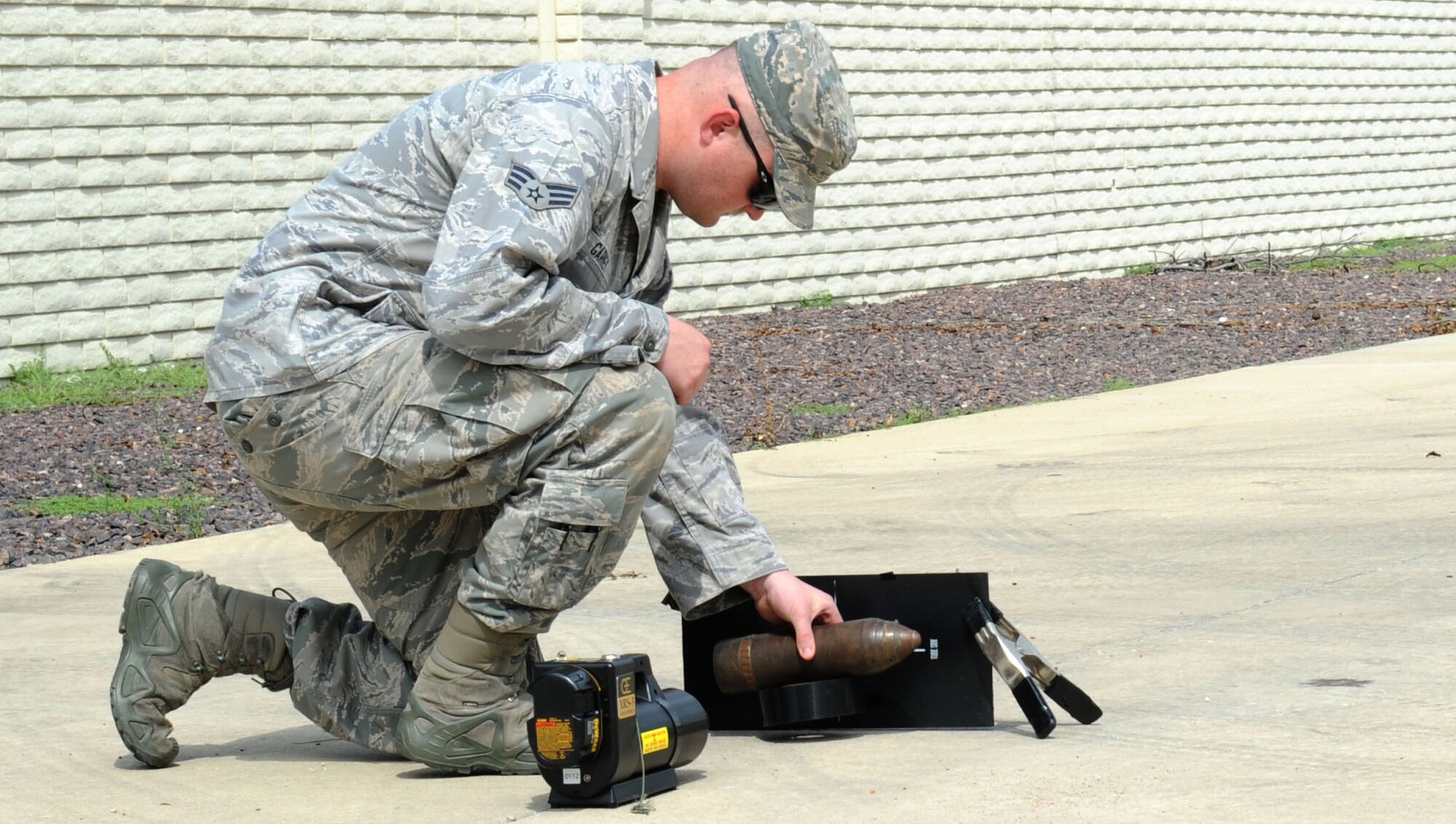 Senior Airman Ryan Garvey, 22nd Civil Engineer Squadron explosive ordnance disposal technician, sets up a portable X-ray machine, Aug. 8, 2016, in Marion County, Kan. Garvey X-rayed a munition item to verify its contents before it was destroyed. (U.S. Air Force photo/Senior Airman Tara Fadenrecht)