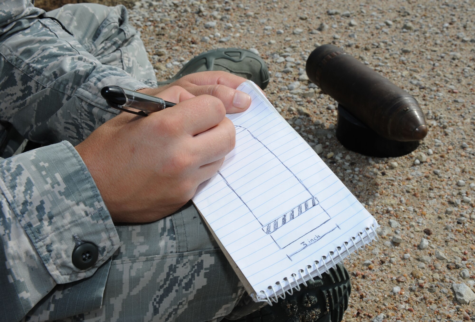 Staff Sgt. James Burnett, 22nd Civil Engineer Squadron explosive ordnance disposal technician, sketches a World War I-era artillery projectile Aug. 8, 2016, in Marion County, Kan. Burnett helped the Marion County Sherriff’s Department identify and dispose of the ordnance. (U.S. Air Force photo/Senior Airman Tara Fadenrecht)