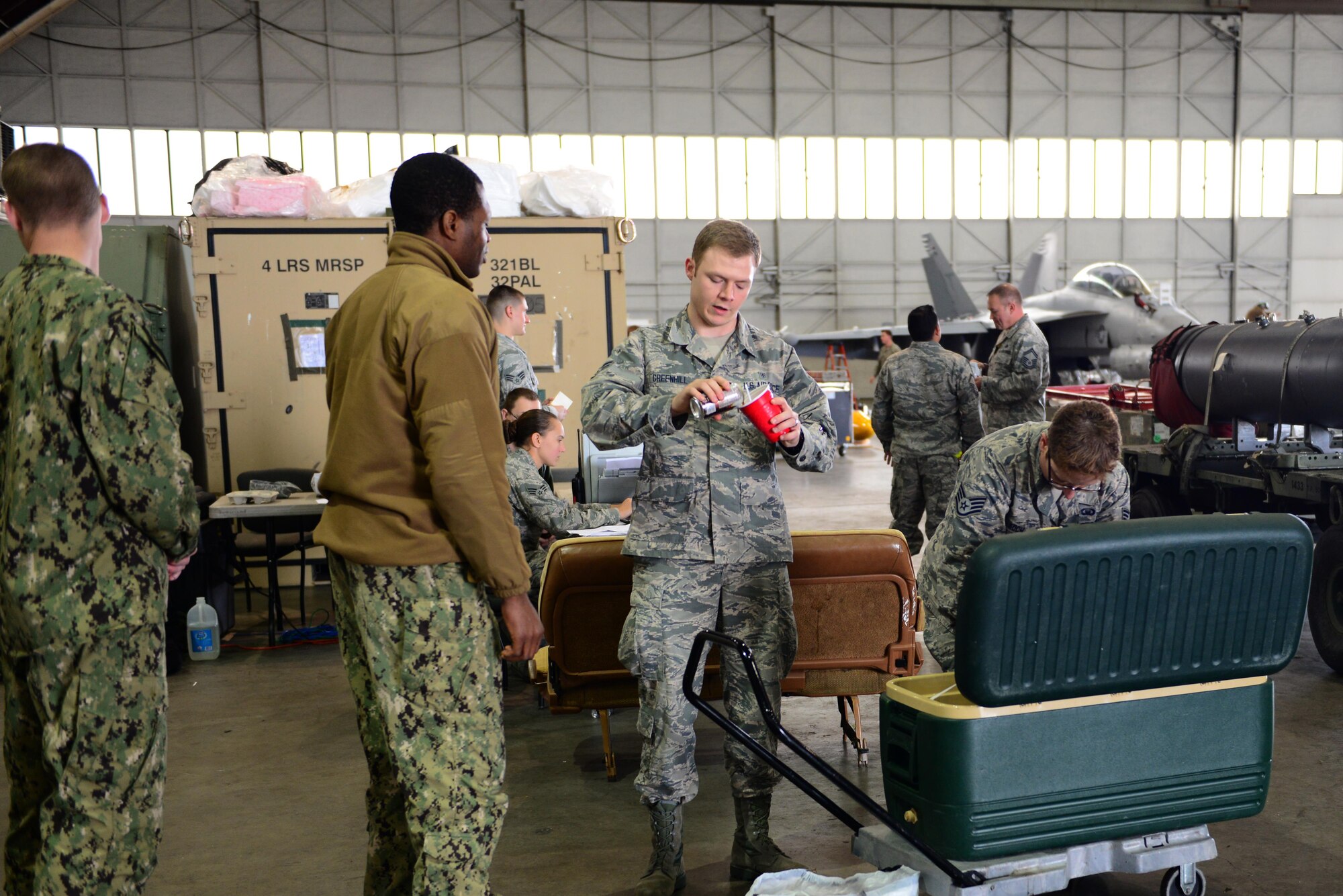 U.S. Air Force Airman 1st Class Terence Greenhill, a 354th Medical Group mental health technician, talks with a U.S. sailor assigned to the Electronic Attack Squadron 135, Naval Air Station Whidbey Island, Wash., while preparing a root beer float for him Aug. 9, 2016, at Eielson Air Force Base, Alaska. The 354th Fighter Wing chapel staff holds morale-boosting events during RED FLAG-Alaska exercises in various locations across the base. (U.S. Air Force photo by Airman1st Class Cassandra Whitman)