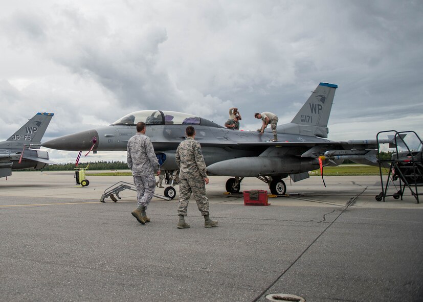 U.S. Air Force Senior Master Sgt. Michael Taylor, the Pacific Air Forces chaplain assistant functional manager, walks with Maj. Brian Anderson, 354th Fighter Wing (FW) command chaplain, Aug. 9, 2016, to interact with units participating in RED FLAG-Alaska 16-3 on the Eielson Air Force Base, Alaska flight line. By talking to visiting Air Force, joint service and multinational units, the command chaplain staff gained a perspective of the 354th FW mission, which includes hosting the command directed exercise. (U.S. Air Force photo by Staff Sgt. Shawn Nickel)