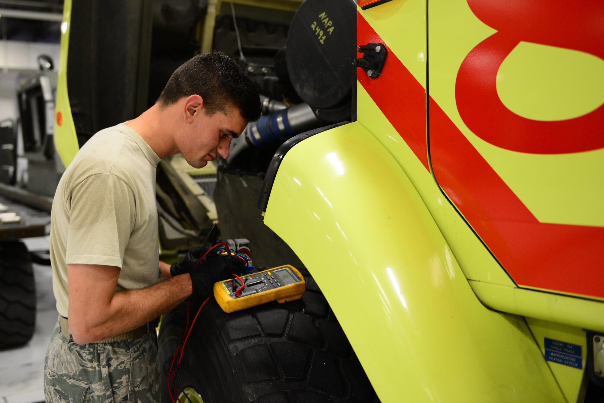 U.S. Air Force Senior Airmen Jonathon Spaeth, a 354th Logistics Readiness Squadron fire truck and refueling maintenance journeyman, performs a test on a fire truck Aug. 10, 2016, at Eielson Air Force Base, Alaska. This test is used to check the resistance in the wires of a power supply for an emergency light bar. (U.S. Air Force photo by Airman 1st Class Cassandra Whitman)