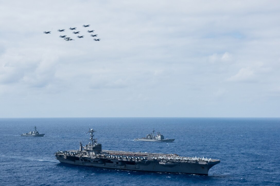 Aircraft assigned to Carrier Air Wing 9 fly in formation over the Nimitz-class aircraft carrier USS John C. Stennis, the Arleigh Burke-class guided-missile destroyer USS William P. Lawrence,  left, and the Ticonderoga-class guided-missile cruiser USS Mobile Bay, right, in the Pacific Ocean, Aug. 7, 2016. Navy photo by Petty Officer 1st Class Bryan Niegel
