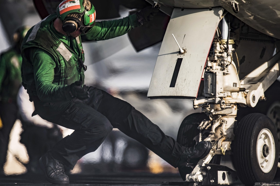 Navy Petty Officer 3rd Class Dakotah Emmerth guides an E-2C Hawkeye onto a catapult on the USS Dwight D. Eisenhower in the Arabian Gulf, Aug. 8, 2016. The Hawkeye is assigned to Airborne Early Warning Squadron 123. Emmerth is an aviation boatswain's mate. The aircraft carrier is supporting Operation Inherent Resolve, maritime security operations and theater security cooperation efforts in the U.S. 5th Fleet area of operations. Navy photo by Petty Officer 3rd Class J. Alexander Delgado
