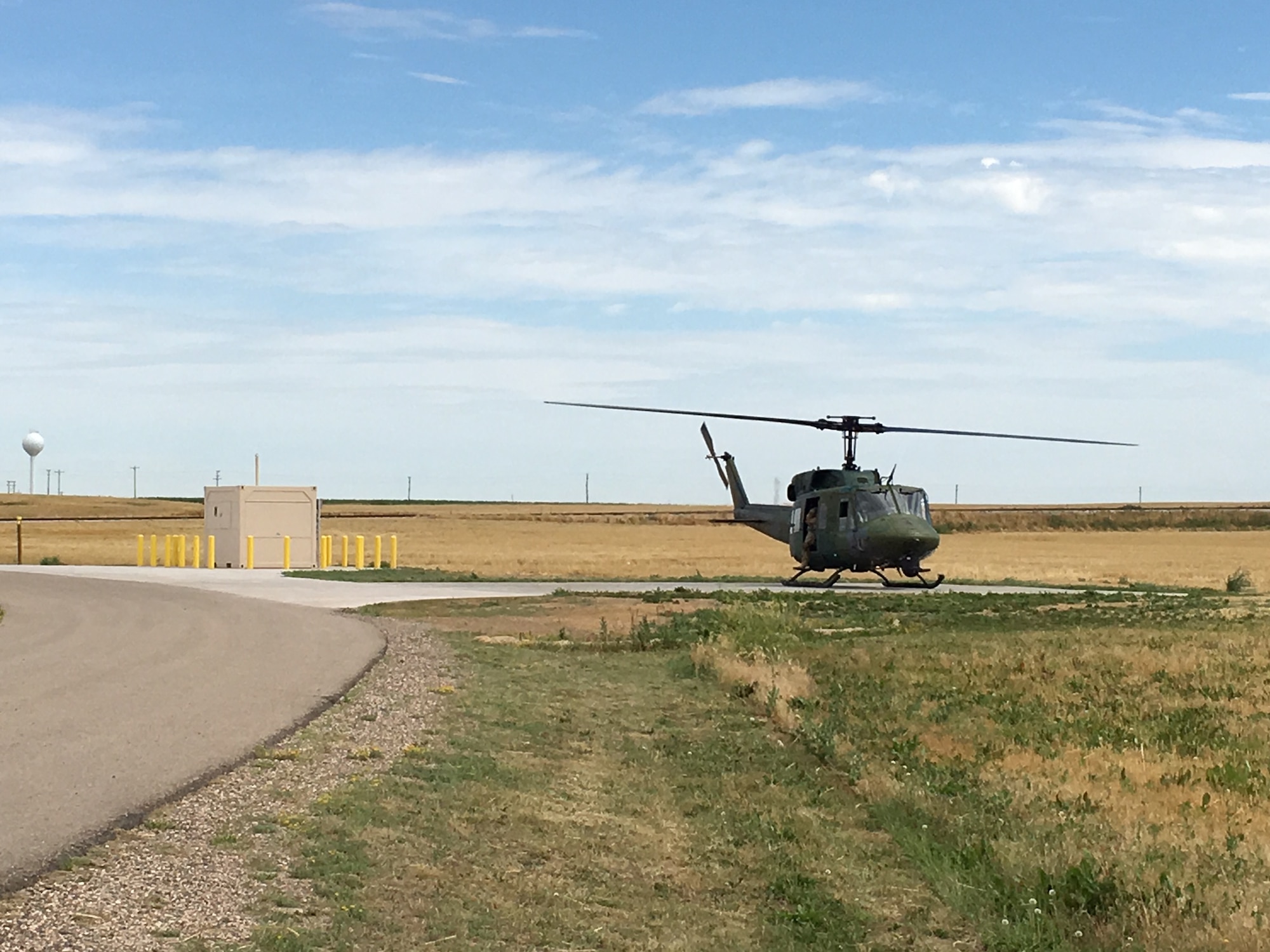 A UH-1N Bell Helicopter from the 37th Helicopter Squadron lands next to a refueling unit at a missile alert facility in the missile complex of F.E. Warren Air Force Base, Wyo. The refueling units will allow helicopter crews to stop at a MAF when they need to refuel. (U.S. Air Force courtesy photo)