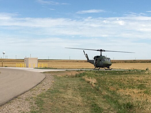 A UH-1N Bell Helicopter from the 37th Helicopter Squadron lands next to a refueling unit at a missile alert facility in the missile complex of F.E. Warren Air Force Base, Wyo. The refueling units will allow helicopter crews to stop at a MAF when they need to refuel. (U.S. Air Force courtesy photo)