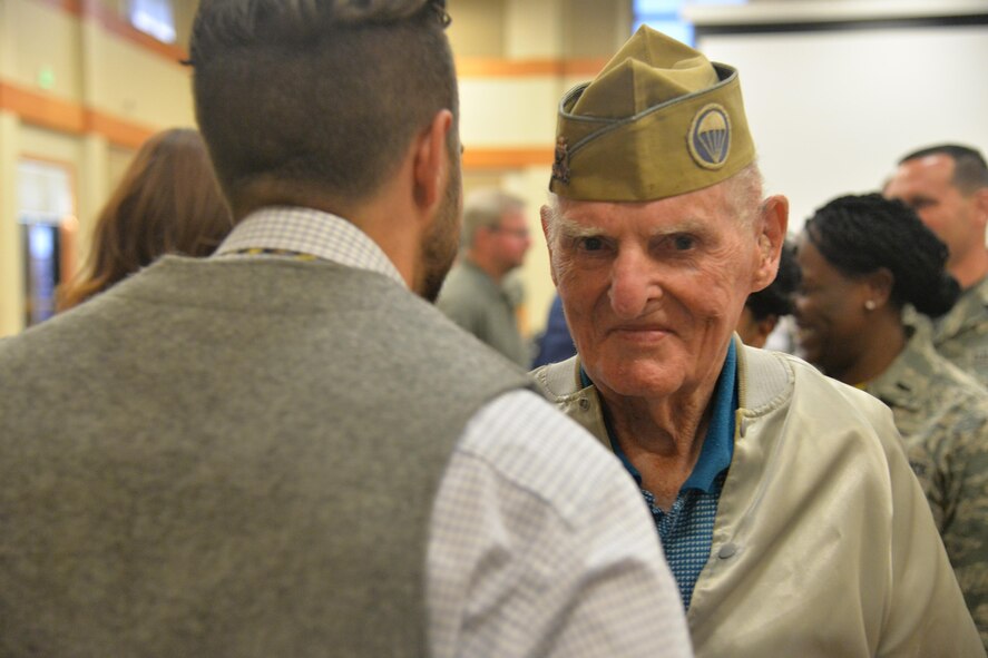 William “Bill” Sullivan, World War II prisoner of war 1944 - 1945, has a conversation at a ceremony held Aug. 5, 2016, at Malmstrom Air Force Base, Mont. Bill received a certificate of recognition and was coined by Brig. Gen. Ferdinand Stoss, Air Force Global Strike Command director of operations, for his service and dedication to the United States military. (U.S. Air Force photo/Airman 1st Class Daniel Brosam)