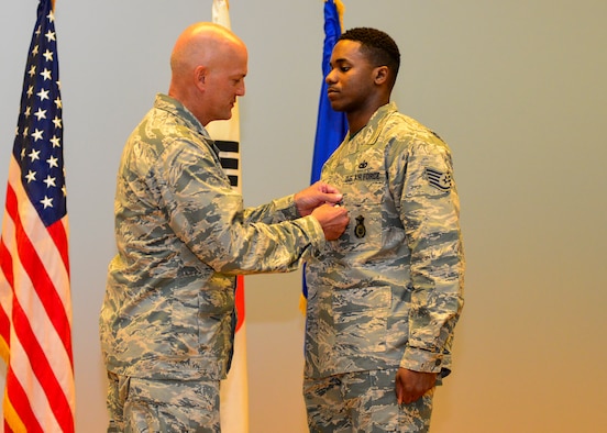 Staff Sgt. Rodney X. Dowell, 51st Security Forces Squadron information assurance NCO, is presented the Airman’s Medal by Col. Andrew Hansen, 51st Fighter Wing commander, at Osan Air Base, Republic of Korea, July 29, 2016. In 2015, Dowell saved the lives of four people trapped in a burning vehicle while he was traveling to work early in the morning. (U.S. Air Force photo by Senior Airman Victor J. Caputo/Released)