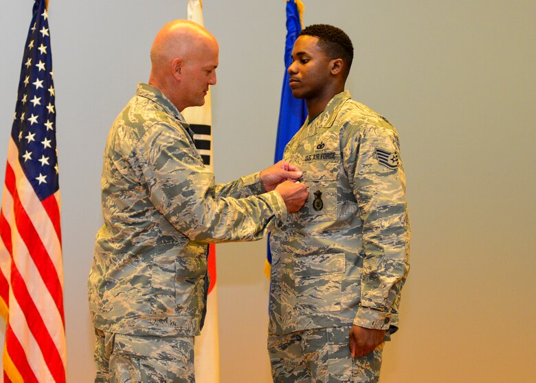 Staff Sgt. Rodney X. Dowell, 51st Security Forces Squadron information assurance NCO, is presented the Airman’s Medal by Col. Andrew Hansen, 51st Fighter Wing commander, at Osan Air Base, Republic of Korea, July 29, 2016. In 2015, Dowell saved the lives of four people trapped in a burning vehicle while he was traveling to work early in the morning. (U.S. Air Force photo by Senior Airman Victor J. Caputo/Released)