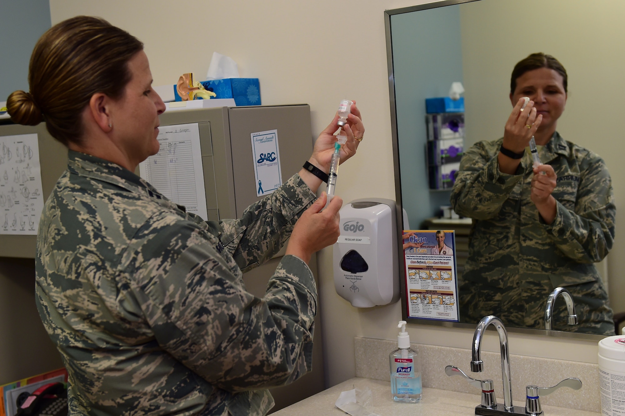Capt. Shelley Murray, 460th Medical group clinical registered nurse, prepares an injection August 11, 2016, at the Veterans Affairs Joint Venture Buckley Clinic in Aurora, Colo. Registered nurses and medical technicians are responsible for assisting doctors and specializing in patient care. (U.S. Air Force photo by Airman 1st Class Gabrielle Spradling/Released)