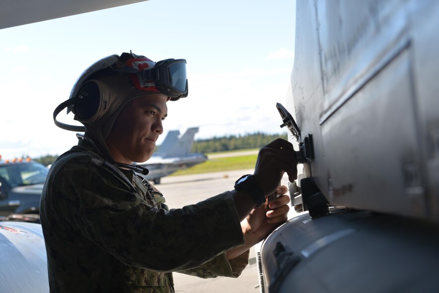 U.S. Navy Seaman Hiapo McCandless, an aviation ordnanceman assigned to Electronic Attack Squadron 135, Naval Air Station Whidbey Island, Wash., works on an ALQ-99 jamming pod on a U.S. Navy EA-18G Growler aircraft Aug. 10, 2016, during RED FLAG- Alaska 16-3, at Eielson Air Force Base, Alaska. The ALQ-99 is a tactical jamming system made to deliver jamming capabilities against radar and communications of enemy air defenses. (U.S. Air Force photo by Airman Isaac Johnson)
