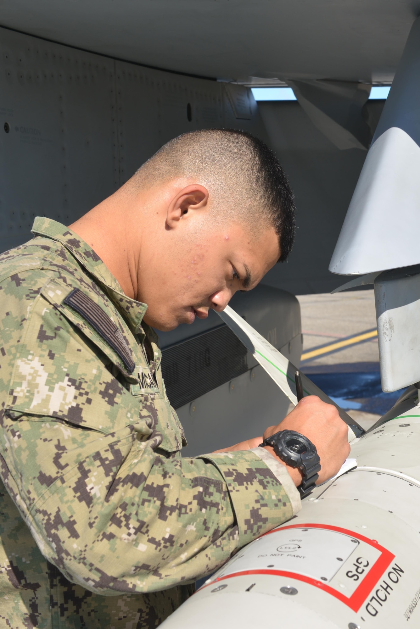 U.S. Seaman Hiapo McCandless, an aviation ordnanceman assigned to Electronic Attack Squadron 135, Naval Air Station Whidbey Island, Wash., writes down meter numbers for an ALQ-99 jamming pod on a U.S. Navy EA-18G Growler aircraft Aug. 10, 2016, during RED FLAG- Alaska 16-3, at Eielson Air Force Base, Alaska. The EA-18G can carry five ALQ-99 jamming pods. (U.S. Air Force photo by Airman Isaac Johnson)
